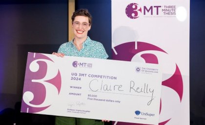 UQ 3MT 2024 winner, Claire Reilly. An award recipient holding up a large cheque